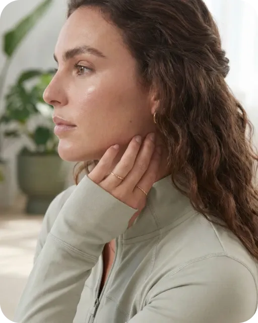 Woman resting her hands at her neck